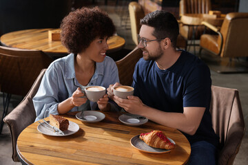 International dating. Lovely couple spending time together in cafe