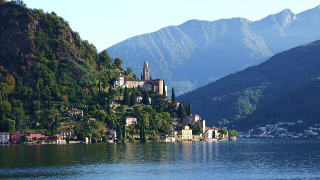 Beautiful Mountain Village Morcote with Church and Lake Lugano and Mountainscape in a Sunny Day in Morcote, Ticino, Switzerland, Europe
