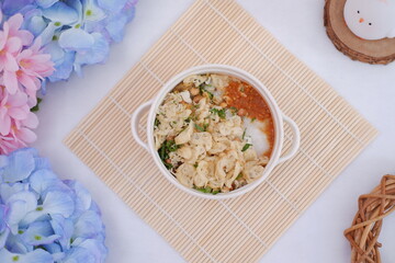 Bubur ayam or rice porridge with shredded chicken