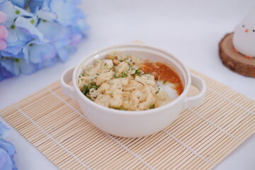 Bubur ayam or rice porridge with shredded chicken