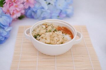 Bubur ayam or rice porridge with shredded chicken
