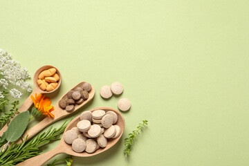 Different pills, herbs and flowers on light green background, flat lay with space for text. Dietary supplements © New Africa