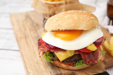 Delicious burger with fried egg on table, closeup. Space for text
