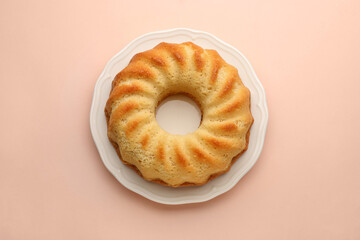 One tasty sponge cake on beige background, top view