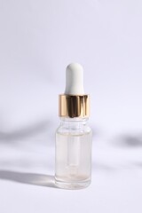Naklejka premium Bottle of cosmetic serum on white background