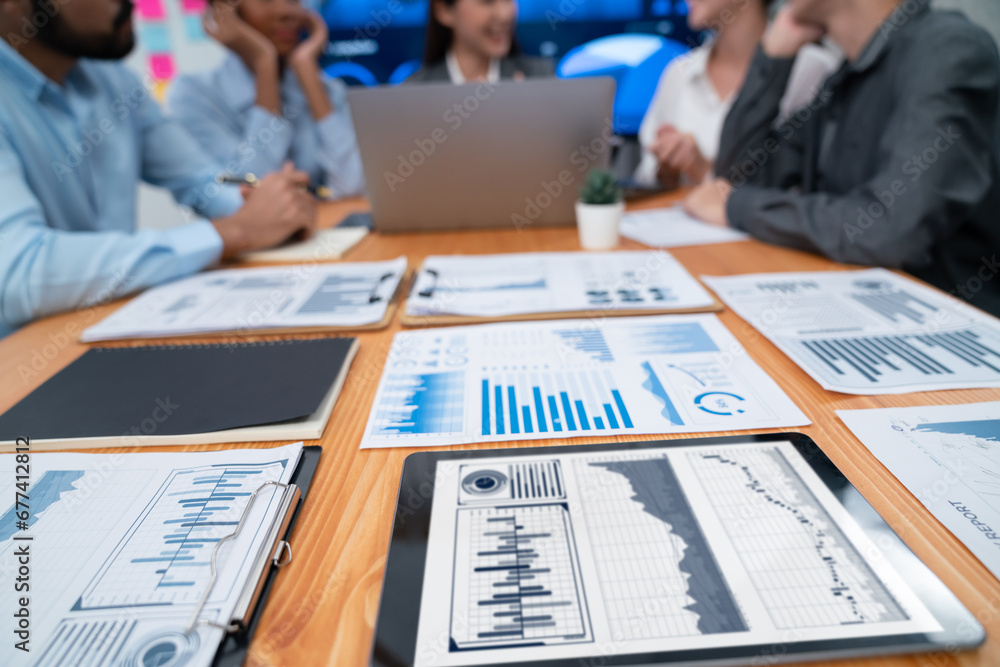 Poster focus financial dashboard paper showing graphs and chart with blurred background of diverse business