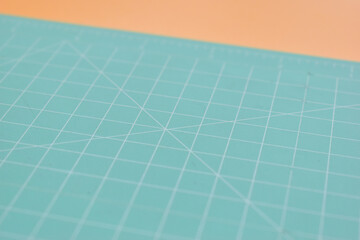 green cutting mat on orange background, object tool for design