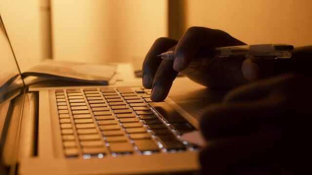 Focused young black man typing using laptop computer for online work