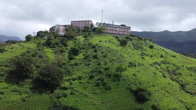 Aerial view of Nil Parvat sacred temple on the edges of Brahmagiri hills surrounded by lush greenery in Trimbakeshwar town, Nashik, Maharashtra, India