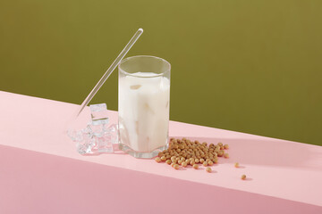 A pile of soybeans decorated with a milk cup, a straw and some ices. The vitamins, minerals, and...