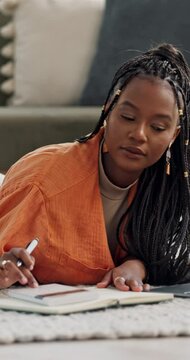 Budget, finance and black woman writing on a floor with calculator, book or research at home. Financial management, notebook and African student in a living room for e learning math upskill course