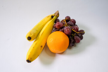 Grapes, bananas and oranges. Natural fruits for healthy eating. Isolated on white background.