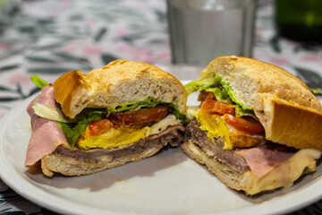 preparation of a tenderloin with rump steak with cheese, egg, bread, mayonnaise, ham and cheese