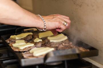 preparation of a tenderloin with rump steak with cheese, egg, bread, mayonnaise, ham and cheese