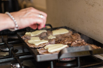 preparation of a tenderloin with rump steak with cheese, egg, bread, mayonnaise, ham and cheese