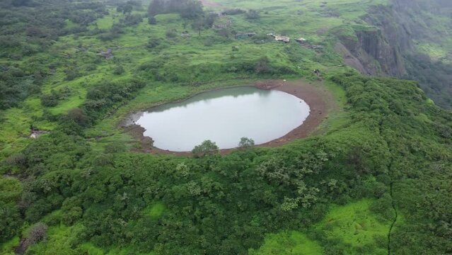 Aerial view of sacred lake at the Brahmagiri hill in the Western Ghats of Maharashtra during monsoon, Nashik, India