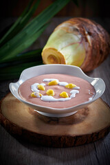 traditional Chinese double boiled healthy teo chew hot yam paste with coconut milk and gingko nut  sweet soup in bowl on dark wood table asian restaurant luxury cafe cuisine halal food dessert menu