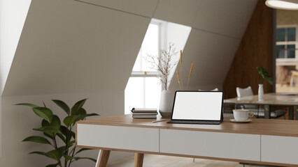 A minimal Scandinavian office with a white-screen tablet and accessories on a minimal wooden desk.