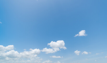 Panoramic view of clear blue sky and clouds, Blue sky background with tiny clouds. White fluffy clouds in the blue sky. Captivating stock photo featuring the mesmerizing beauty of the sky and clouds.