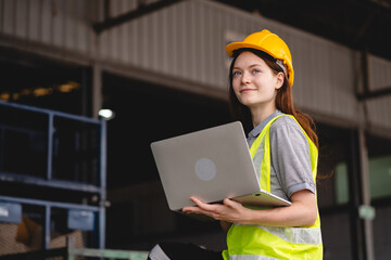 Portrait female professional engineer factory in protective uniform operating machine, Engineering worker in safety hardhat at warehouse industrial facilities, Heavy Industry Manufacturing