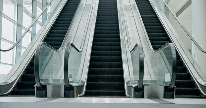 Escalator moving, machine and empty airport for travel in interior of building. Electronic, stairs and movement in office, mall or hotel technology for transportation on steps, stairway or staircase