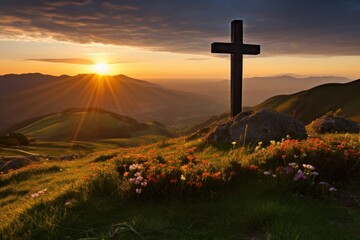 a cross on a hill with flowers and mountains in the background