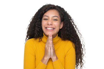 Fototapeta na wymiar Lovely curly hair young woman on a white background gearing a yellow sweater palms together begging or praying with a big smile