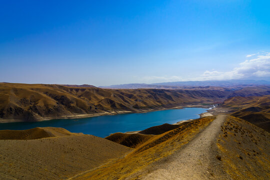 A deserted part of the Zaamin nature reserve in Uzbukistan on a sunny summer day. View of the mountains and reservoir.