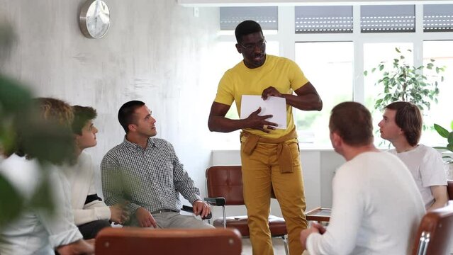 African american man leads a lecture in the audience during a meeting of men gays. . High quality 4k footage