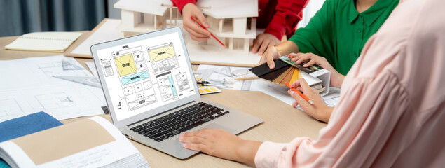 Cropped image of interior designer team discuss the material color while laptop displayed website...