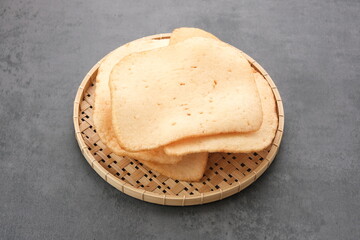 Kerupuk Udang, Crispy Prawn Crackers in bamboo plate. 
