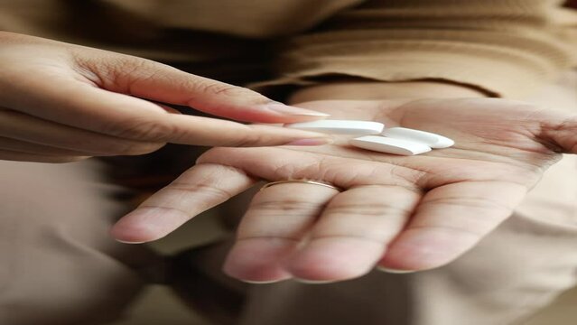  top view of women hand taking medical tablet 