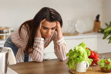 Obraz na płótnie Canvas Young woman having panic attack in kitchen