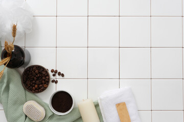 On the white tiles background, natural ingredient - coffee beans and powder on bowls decorated with...