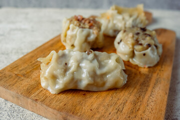 Dim sum with various fillings, from chicken, carrots, mushrooms and shrimp served with sauce.