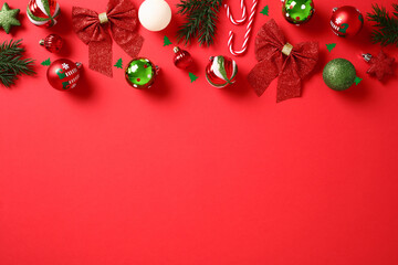Elegant Christmas composition. Chic red background adorned with glittering balls, creating a...