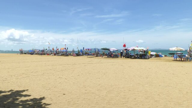 Fishermen are sorting out their fishing gear such as nets, ice boxes, buoys, as they prepare to go fishing while some are preparing some dishes with their fresh catch in Pattaya Beach, Thailand.