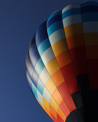 Colorful Hot Air Balloon Lifting Off into the Clear Blue Sky