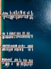 Marina in the Mediterranean Sea, moored boats in a row, top view, photograph from a drone