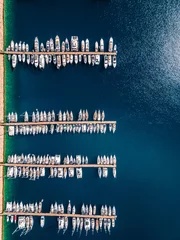 Fotobehang Marina in the Mediterranean Sea, moored boats in a row, top view, photograph from a drone © Artem Orlyanskiy