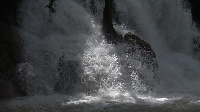 Slow motion of Beautiful Clear Waterfall Cascade In Tropical Rainforest, Kuang Si Falls In Luang Prabang, Laos