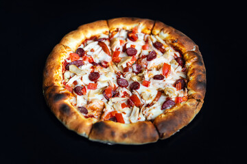 Delicious classic italian Pizza Pepperoni with sausages and cheese mozzarella. black dark background