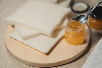 Breakfast with bread and jam on the wooden table