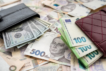 Money 100 dollars and  100 euros in wallet vs 500 1000 ukrainian hryvnia. exchange concept