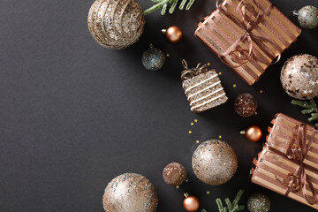 Elegant Christmas flat lay composition with chic copper baubles and gift boxes on dark background....