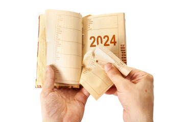 2024 man hands pulling out  page from notebook close-up