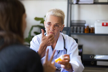 Doctor giving pill to female patient at medical office in hospital. medicine, healthcare concept