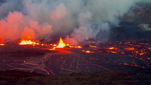 Cinematic long lens panning shot across the illuminated lava lake at Kilauea at sunset on the first evening of eruption in September 2023 at Hawai'i Volcanoes National Park. 4K HDR at 30 FPS