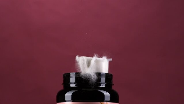 Protein powder spoon hit the top of the container in super slow motion.
packaging shot with with powder 