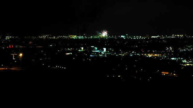 Aerial Shot Of Fireworks Exploding In Illuminated City Against Dark Clear Sky At Night - Culver City, California